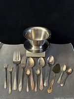 Group shot of stainless bowl and all mixed flatware pieces