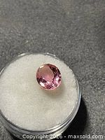 Pink faceted oval tourmaline in gem jar