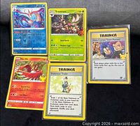 All five Pokémon TCG cards in sleeves displayed front side