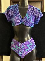 Front view of crop top and high-waisted bottom on mannequin