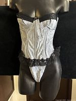 Front view of silver satin bustier corset on mannequin