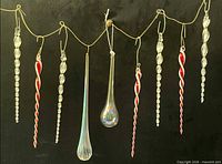Full set of nine glass icicle ornaments hanging