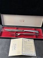 Knife and fork set in original box with paperwork displayed