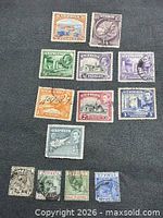 Full set of 14 Cyprus stamps spread on dark background