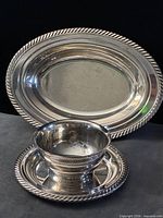 Front view showing oval platter behind bowl with underplate