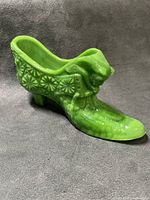 Left side view of green slag glass shoe showing embossed pattern