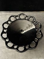 Top view showing lace rim and black glass surface