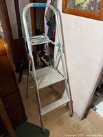 Full view of aluminum 2-step folding ladder, folded position