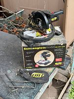 Full view of mitre saw on top of box with dust bag