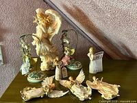 Group shot of all seven resin angel pieces on dresser