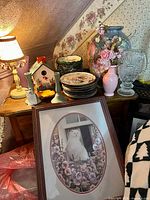 Overview of all decorative objects on washstand top including cat print leaning in front