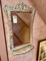 Front view of mirror showing shelf and frame