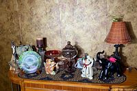 Wide view of all decorative items on dresser surface