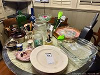 overview of tabletop items including knife block, dishes, baking dishes, utensils and decorative pieces