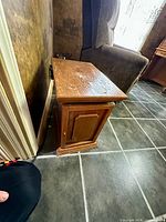 Angle view of wooden side table next to chair