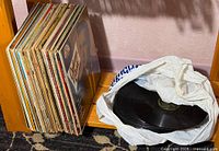 Stack of LP records and bag of 78s on shelf