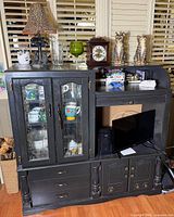 Full view of cabinet with contents on top and inside
