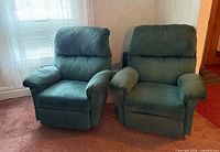 Front view of both green lounge chairs side by side