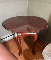 Full view of one Queen Anne style oval drop-leaf side table
