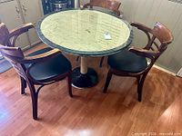 Table with three of the four chairs visible