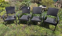 All four resin wicker patio chairs side by side on lawn