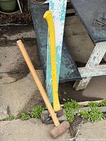 Sledgehammer and axe leaning against steps