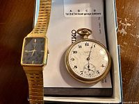 Seiko wristwatch and Waltham pocket watch together in box