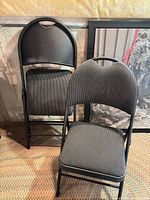Both folding chairs, one open one folded