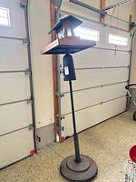 Full view of pole system with base, baffle and feeder