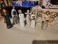Six figurines standing in a row on table