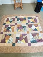 Full view of quilt laid flat showing star block pattern and border