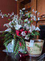 Full view of floral arrangement, glass bird, tin pail