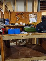 Overall view of workbench with vise, tools, hardware bins