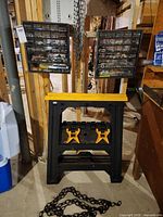 Overall lot showing two drawer cabinets, sawhorses and chains