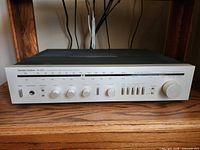 Front view of Harman Kardon hk330i receiver on shelf