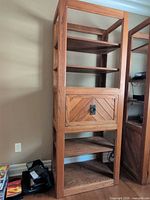 Full view of oak wall unit showing shelves, drop-down door, overall design