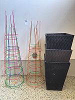 stacked plastic wicker planters with metal plant cages