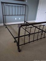 Full view of assembled metal queen bed frame showing headboard and footboard