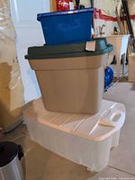 All three containers stacked: clear tote bottom, grey Rubbermaid RoughTote middle, blue recycling bin top