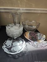 Group shot showing vase, stack of dessert bowls, art deco fruit bowl, coloured serving bowl