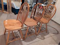 Three wood hoop back dining chairs front and side view
