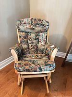 Front view of glider showing wood frame and patterned upholstery