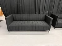 Front view of black Kurtis sofa showing upholstery and legs