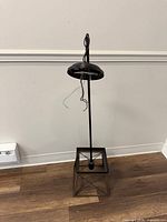 Full view of pendant light fixture standing upright showing round canopy, downrod and square lantern cage