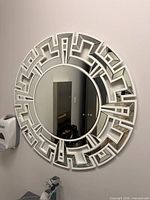 Front view of round mirror mounted on wall