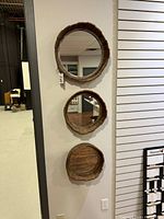 Front view of all three wood round mirrors mounted vertically