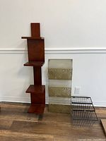 Overall view of all three items: wood shelf, gold file holder, black wire basket