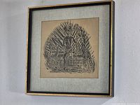 Framed square brass rubbing artwork on wall