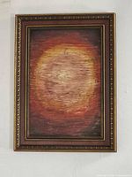 Frontal view of framed sunburst oil painting