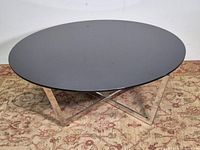 Full view showing circular tinted glass top and X base